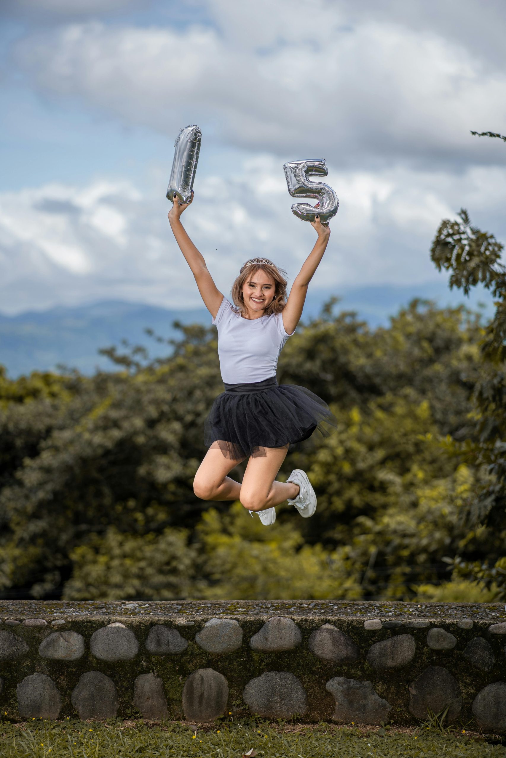 Woman Jumps over Stone Wall